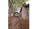 Side yard view, showing a stone chimney and carport at 13225 2Nd E St, Madeira Beach, FL 33708