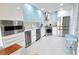 Modern kitchen with stainless steel appliances and light blue cabinets at 1515 Pinellas Bayway S # 70, Tierra Verde, FL 33715