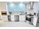 Modern kitchen with stainless steel appliances and light blue cabinets at 1515 Pinellas Bayway S # 70, Tierra Verde, FL 33715