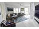 Bright living room with sectional sofa, large artwork, and whitewashed floors at 1515 Pinellas Bayway S # 70, Tierra Verde, FL 33715