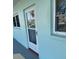 Condo building entry with a light teal exterior and glass door at 1819 Shore S Dr # 203, South Pasadena, FL 33707