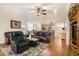 Spacious living room with hardwood floors, leather furniture, and a view of the kitchen at 315 19Th Nw St, Ruskin, FL 33570