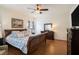 Main bedroom with wood flooring, a king-size bed, and plenty of storage at 315 19Th Nw St, Ruskin, FL 33570
