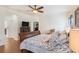 Main bedroom with wood flooring, king-size bed, and access to the bathroom at 315 19Th Nw St, Ruskin, FL 33570