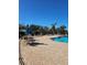 Community pool with tables, chairs, and lounge chairs at 315 19Th Nw St, Ruskin, FL 33570