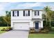Two-story house with white siding, blue shutters, and a two-car garage at 3503 Rosewood Ramble Ct, Plant City, FL 33565