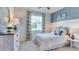Bedroom with a full bed, dresser, and window with light blue wall at 3548 Thistle Bank Ct, Plant City, FL 33565