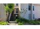 Exterior view of condo building with stairs, landscaping, and building number visible at 4745 Puritan Cir # 4745, Tampa, FL 33617