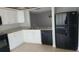 Modern kitchen with white cabinets, granite countertops, and black appliances at 4745 Puritan Cir # 4745, Tampa, FL 33617