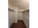 Large walk-in closet with double hanging rods and carpeted floor at 4895 Bay Ne St # 211, St Petersburg, FL 33703