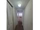 Long hallway with two closets and view into another room at 4895 Bay Ne St # 211, St Petersburg, FL 33703