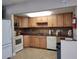 Well-equipped kitchen with light wood cabinets and granite countertops at 4895 Bay Ne St # 211, St Petersburg, FL 33703