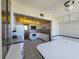 Kitchen features white cabinetry, built-in dinette, and appliances at 4895 Bay Ne St # 211, St Petersburg, FL 33703
