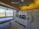 Kitchen with white cabinets, appliances, and window overlooking the outdoors at 4895 Bay Ne St # 211, St Petersburg, FL 33703