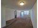 Bright living room with carpeting, large window, and entry door at 4895 Bay Ne St # 211, St Petersburg, FL 33703