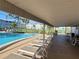 Relaxing poolside patio with lounge chairs, a covered area, and grill at 4895 Bay Ne St # 211, St Petersburg, FL 33703