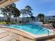 Inviting kidney-shaped swimming pool with lounge chairs and a surrounding patio at 4895 Bay Ne St # 211, St Petersburg, FL 33703