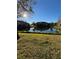 Peaceful backyard with a scenic lake view and sunny skies at 5153 Bay Isle Cir, Clearwater, FL 33760