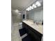 Bathroom with a double sink vanity, walk-in shower, and tile flooring at 5153 Bay Isle Cir, Clearwater, FL 33760