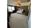 Spacious bedroom featuring a ceiling fan, large window, and neutral decor at 5153 Bay Isle Cir, Clearwater, FL 33760