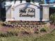 Community entrance sign for Bay Isle Landings with colorful flower bed at 5153 Bay Isle Cir, Clearwater, FL 33760