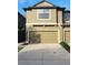 Two-story townhome with tan exterior, attached garage and concrete driveway at 5153 Bay Isle Cir, Clearwater, FL 33760