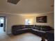 Open-concept living room with a cozy sectional sofa and neutral color scheme at 5153 Bay Isle Cir, Clearwater, FL 33760