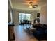 Bright living area with dining table, dark blue sectional couch, and backyard view at 5153 Bay Isle Cir, Clearwater, FL 33760