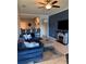 Comfortable living area with blue sectional couch, modern fireplace, and adjacent kitchen at 5153 Bay Isle Cir, Clearwater, FL 33760