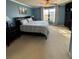 Bright main bedroom with large window, carpeted floors, and ceiling fan at 5153 Bay Isle Cir, Clearwater, FL 33760