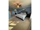 Spacious bedroom with a ceiling fan, a king size bed, and an ensuite bathroom at 5153 Bay Isle Cir, Clearwater, FL 33760