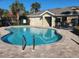 Beautiful community pool with a slide, lounge seating, and well-maintained patio at 5153 Bay Isle Cir, Clearwater, FL 33760