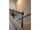 Elegant staircase with dark wood banister and wrought iron spindles at 5153 Bay Isle Cir, Clearwater, FL 33760