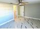 Bright bedroom with ceiling fan and modern flooring at 6220 Westport Dr, Port Richey, FL 34668