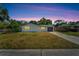 House exterior at dusk with a spacious front yard at 6220 Westport Dr, Port Richey, FL 34668