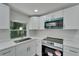Modern kitchen with white cabinets and stainless steel appliances at 6220 Westport Dr, Port Richey, FL 34668
