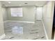 Bright and spacious living area with marble-look flooring at 6220 Westport Dr, Port Richey, FL 34668