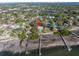 Bird's-eye view showcasing waterfront property, pool, and lush landscape at 7172 Dr Martin Luther King Jr S St, St Petersburg, FL 33705