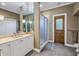 Elegant bathroom features a double vanity, large shower, and access to bedroom at 7172 Dr Martin Luther King Jr S St, St Petersburg, FL 33705