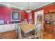 Bright dining room with a large wooden table and red walls at 7172 Dr Martin Luther King Jr S St, St Petersburg, FL 33705