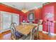Bright dining room with a large wooden table and red walls at 7172 Dr Martin Luther King Jr S St, St Petersburg, FL 33705