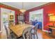 Formal dining room with a large wooden table and red walls at 7172 Dr Martin Luther King Jr S St, St Petersburg, FL 33705