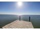 Wooden dock on calm water under a sunny sky at 7172 Dr Martin Luther King Jr S St, St Petersburg, FL 33705