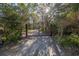 Private gated entrance leading to a tree-lined driveway at 7172 Dr Martin Luther King Jr S St, St Petersburg, FL 33705