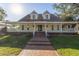 Two-story house with a wraparound porch and a brick walkway at 7172 Dr Martin Luther King Jr S St, St Petersburg, FL 33705