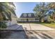 Two-story house with a large front porch and attached garage at 7172 Dr Martin Luther King Jr S St, St Petersburg, FL 33705