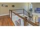 Upstairs hallway featuring hardwood floors and a wooden railing at 7172 Dr Martin Luther King Jr S St, St Petersburg, FL 33705