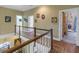 Upper hallway with hardwood floors and access to bedrooms at 7172 Dr Martin Luther King Jr S St, St Petersburg, FL 33705