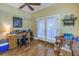 Home office with hardwood floors, built-in desk and access to patio at 7172 Dr Martin Luther King Jr S St, St Petersburg, FL 33705