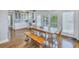 Bright kitchen with white cabinets, wood floors, and a farmhouse table at 7172 Dr Martin Luther King Jr S St, St Petersburg, FL 33705